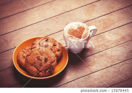 Cookie and cup of coffee on wooden table. Cookie and cup of coffee on wooden table. 13876445