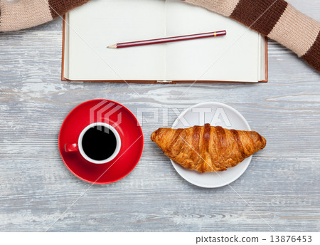 Cup, croissant and book with scarf on wooden table. Cup, croissant and book with scarf on wooden table. 13876453