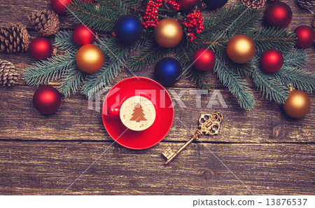 Hot cappuccino with christmas tree shape on a wooden table near 13876537