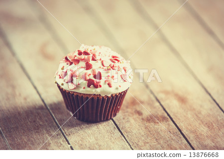 Cream cake on a wooden table. 13876668