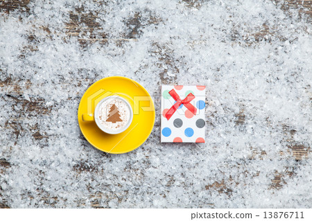 Cappuccino with christmas tree shape and gift box on artificial Cappuccino with christmas tree shape and gift box on artificial 13876711