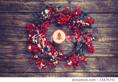 Holly christmas wreath on wooden table. 13876741