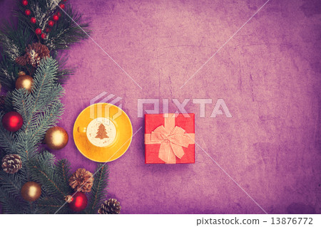 Cappuccino with christmas tree shape and gift box on violet back Cappuccino with christmas tree shape and gift box on violet back 13876772
