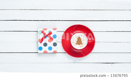 Gift box and cappuccino on white wooden table. 13876795