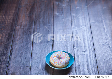Donut on wooden table. 13876914