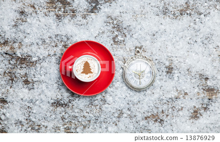 Cappuccino with christmas tree shape and clock on artificial bac 13876929