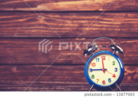 Retro alarm clock on a table. Photo in retro color image style Retro alarm clock on a table. Photo in retro color image style 13877083