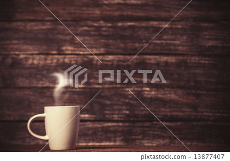 Tea or coffee cup on wooden table. Tea or coffee cup on wooden table. 13877407