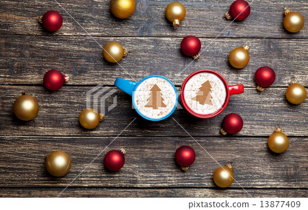 Two cappuccino with christmas tree shape on wooden table. Two cappuccino with christmas tree shape on wooden table. 13877409