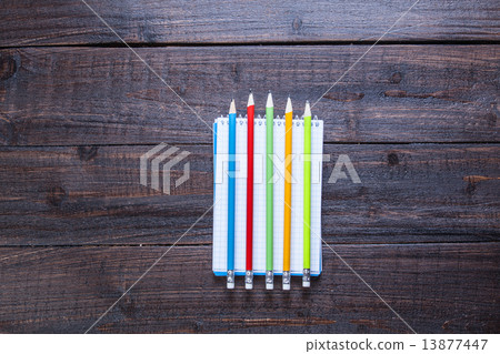 Pencils and notebook on wooden table Pencils and notebook on wooden table 13877447