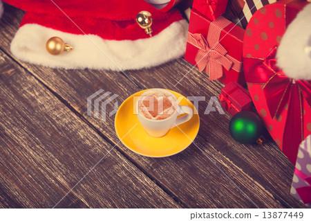 Cup of coffee with heart shape with christmas gifts. 13877449