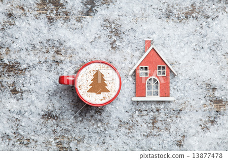 Cappuccino with christmas tree shape and toy home on artificial 13877478