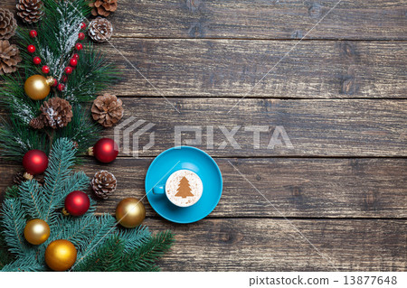 Cappuccino with christmas tree shape and pine branch on wooden t Cappuccino with christmas tree shape and pine branch on wooden t 13877648
