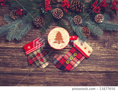 Hot cappuccino with christmas tree shape on a wooden table near Hot cappuccino with christmas tree shape on a wooden table near 13877650