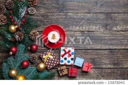 Cappuccino with christmas tree shape and gifts on wooden table. 13878041