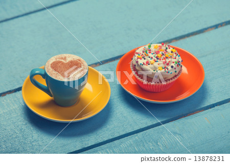 Cup of coffee and cupcake on wooden table. Cup of coffee and cupcake on wooden table. 13878231