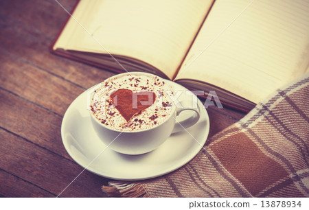 Cup of coffee and book with scarf 13878934