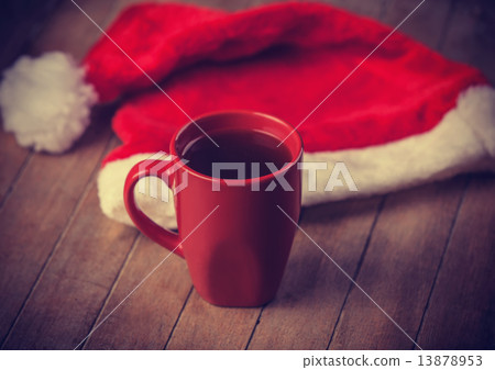 Cup of coffee and red hat. 13878953