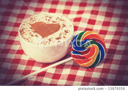 Cup of coffee with tartan and lollipop Cup of coffee with tartan and lollipop 13879350