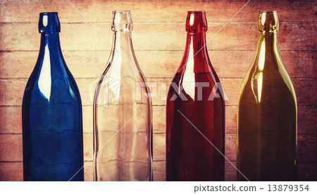 Four empty bottles of wine on wooden background Four empty bottles of wine on wooden background 13879354