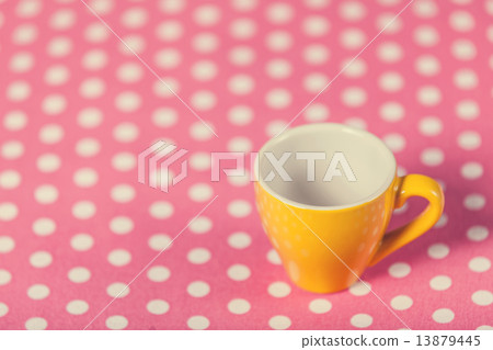 Cup of a coffe on polka dot cover 13879445
