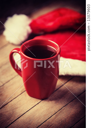Cup of coffee and red hat. 13879603