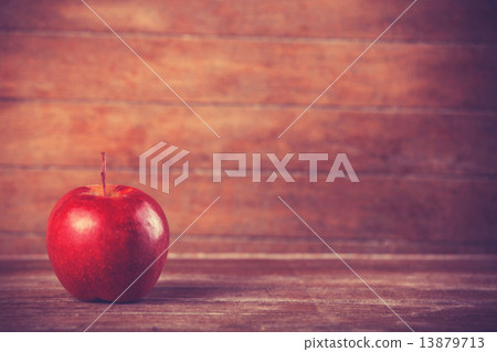 red apple on wooden table red apple on wooden table 13879713