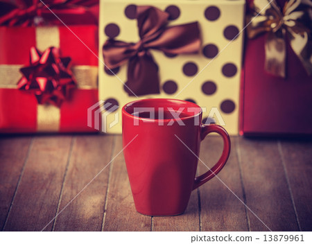 Cup of coffee and gifts at background Cup of coffee and gifts at background 13879961