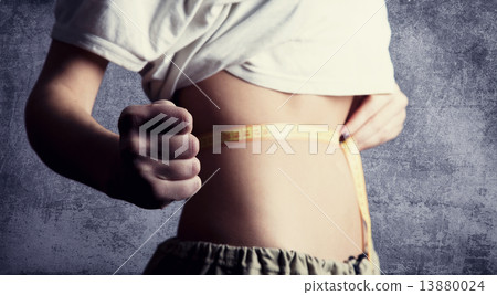 Beautiful and strong women's abs with metre. Studio shot. Beautiful and strong women's abs with metre. Studio shot. 13880024
