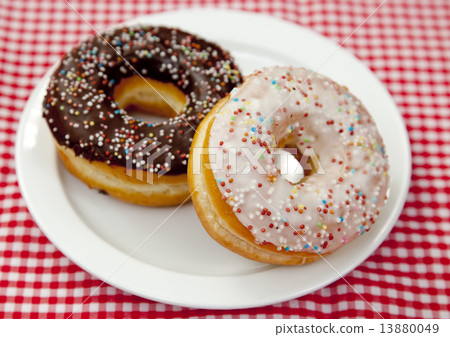A couple of donuts on table. A couple of donuts on table. 13880049