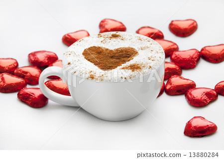 Cup of coffee with heart symbol and candy around. Cup of coffee with heart symbol and candy around. 13880284