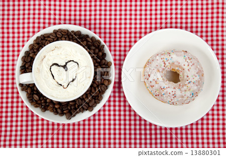 donuts with coffee on table. 13880301