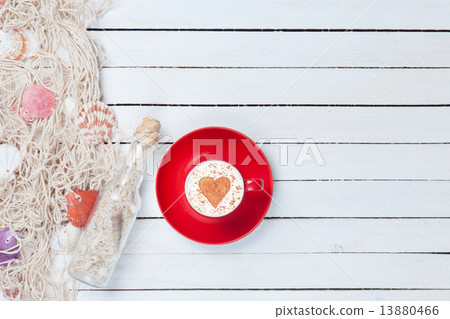 Cup of Cappuccino and net with bottle 13880466