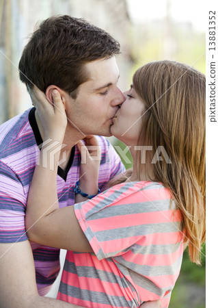 Young couple kissing near graffiti background. 13881352