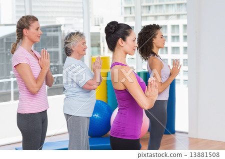 Female friends with hands clasped standing in gym 13881508