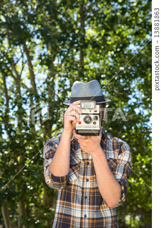 Handsome hipster using vintage camera 13881863