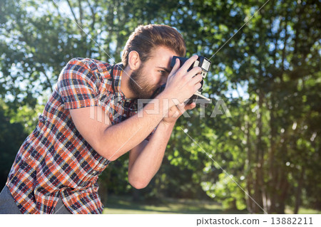 Handsome hipster using vintage camera Handsome hipster using vintage camera 13882211