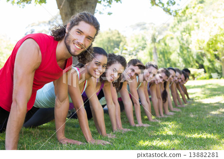 Fitness group planking in park 13882281