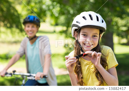 Mother and daughter on their bike 13882417