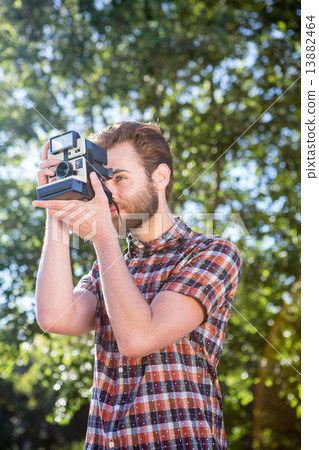 Handsome hipster using vintage camera 13882464