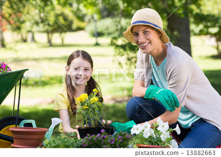 Happy blonde and her daughter gardening 13882663