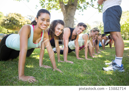 Fitness group planking in park 13882714