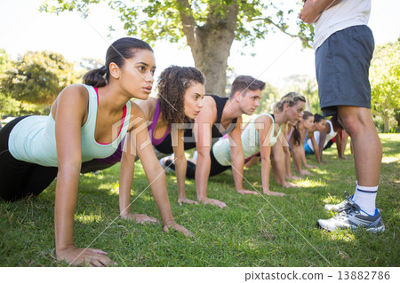 Fitness group planking in park 13882786