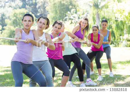 Fitness group playing tug of war Fitness group playing tug of war 13882818