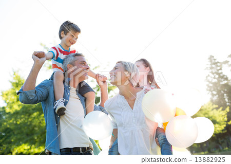 Happy family walking at the park Happy family walking at the park 13882925
