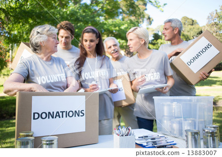 Happy volunteer family holding donation boxes 13883007