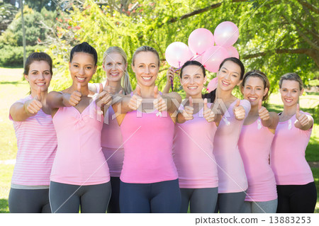 Smiling women in pink for breast cancer awareness Smiling women in pink for breast cancer awareness 13883253