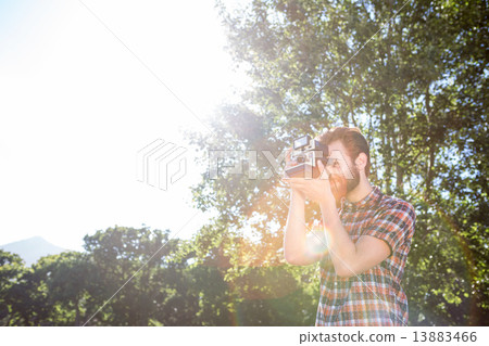 Handsome hipster using vintage camera 13883466