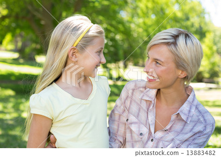 Pretty blonde with her daughter in the park 13883482