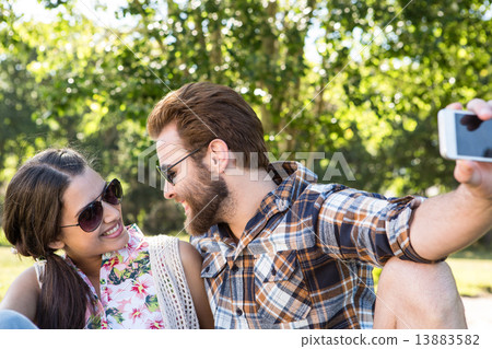 Young couple taking a selfie Young couple taking a selfie 13883582
